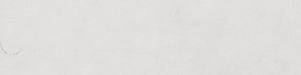 scratchy black ink brush stroke on a beige paper background with many fibers visible at the beginning and end of the stroke which gets fuller and thicker in the middle as the wavy line gets drawn on